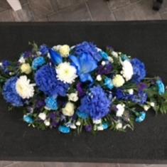 Blue and white casket spray