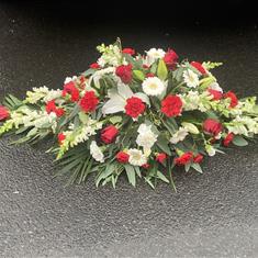 Red and white casket spray 