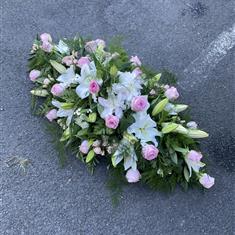Pink roses white lily casket spray